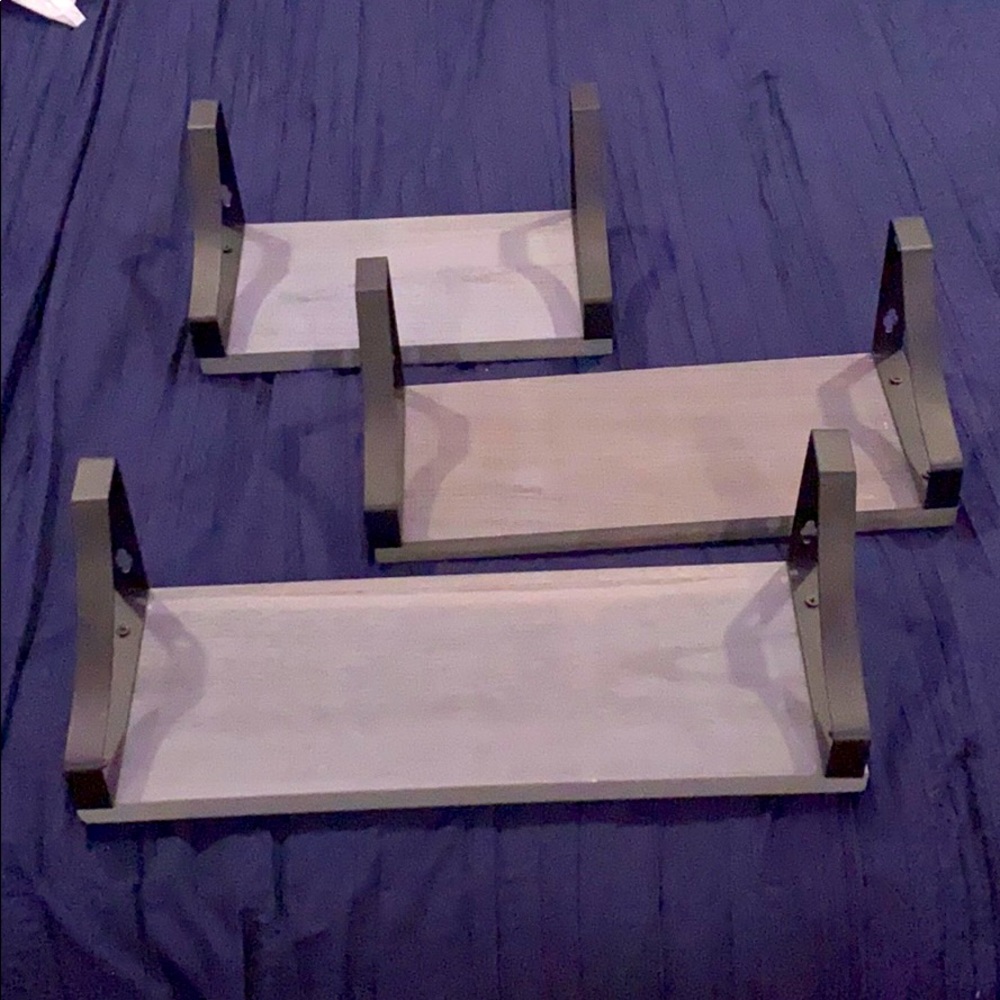 three different sized grey shelves